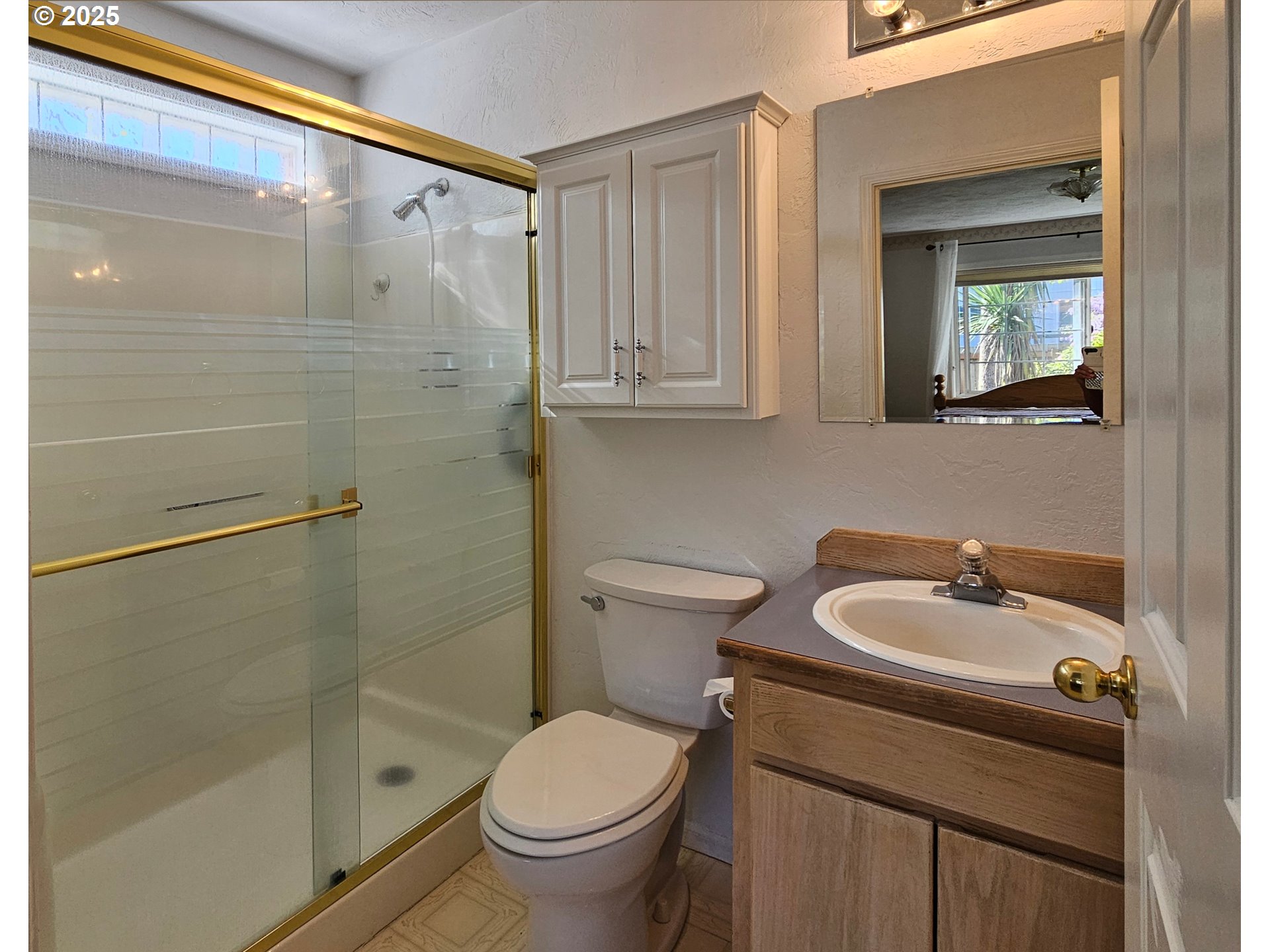 6827 D Street Springfield, OR 97478 - Photo 10 of 23 a bathroom with a sink a toilet and shower