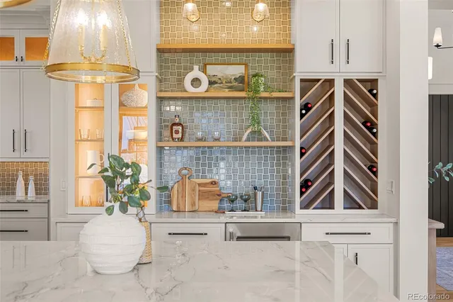 a large kitchen with a large counter top appliances and a view of living room