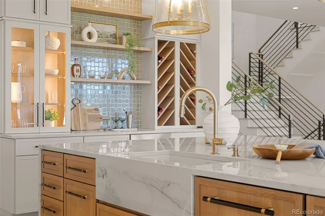 a large kitchen with kitchen island a large window a sink and stainless steel appliances