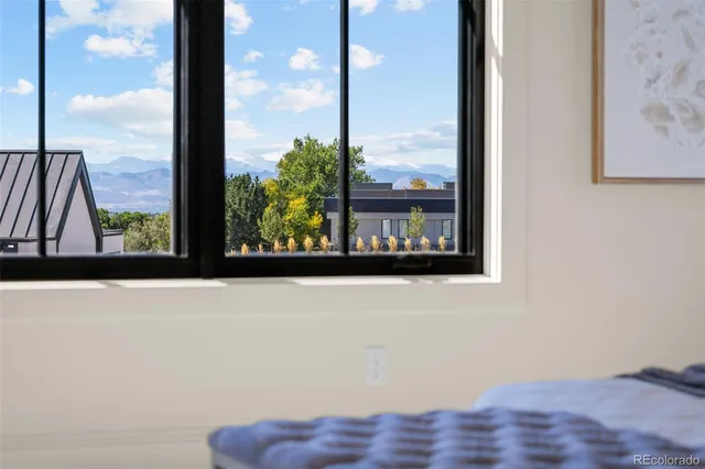 a spacious bedroom with a bed a fireplace and windows