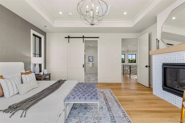 a bathroom with a granite countertop sink a toilet a mirror and shower
