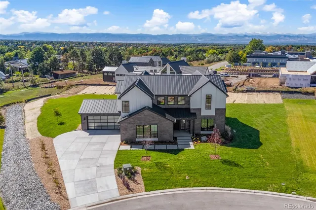 an aerial view of a house with swimming pool garden and patio