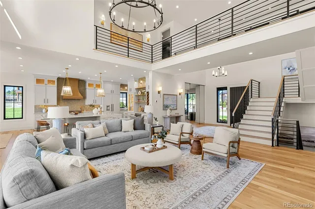 a living room with furniture kitchen view and a table