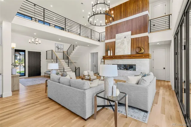 a living room with fireplace furniture and a wooden floor