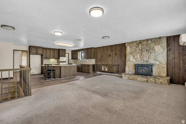10705 Green Ridge Drive Sandy, UT 84070 - Photo 7 of 55 Unfurnished living room with dark carpet, baseboard heating, and wood walls