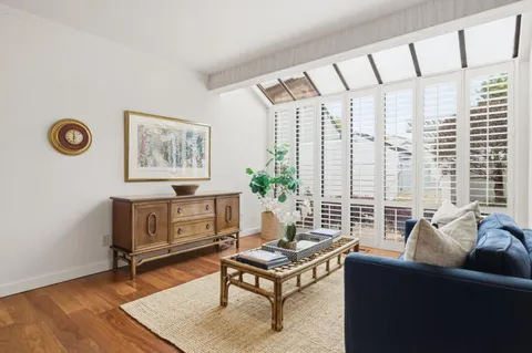 a living room with furniture and a floor to ceiling window