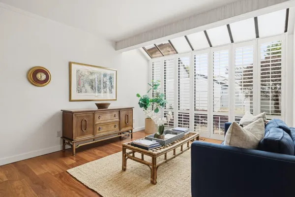 a living room with furniture and a floor to ceiling window