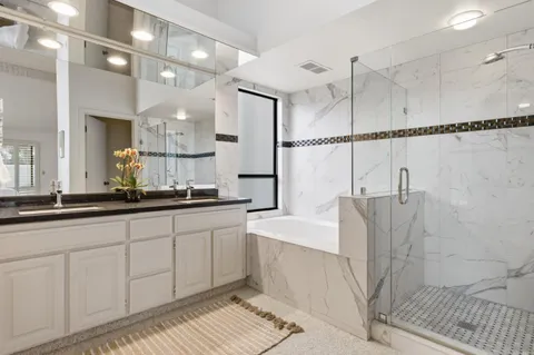 a large bathroom with a double vanity sink a mirror and shower
