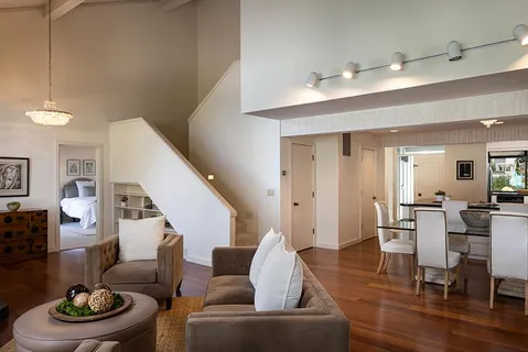 a living room with furniture and a wooden floor