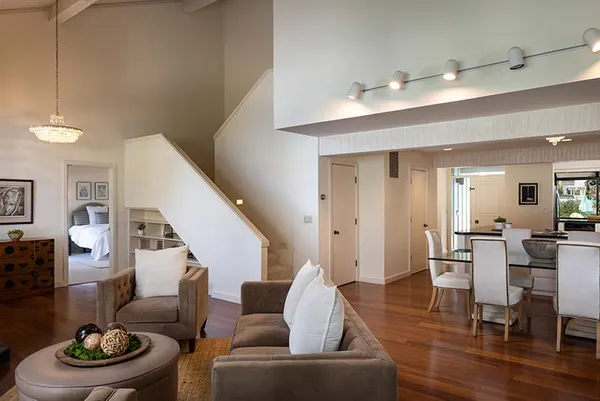 a living room with furniture and a wooden floor