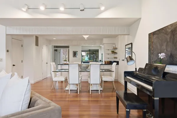 a living room with furniture and wooden floor