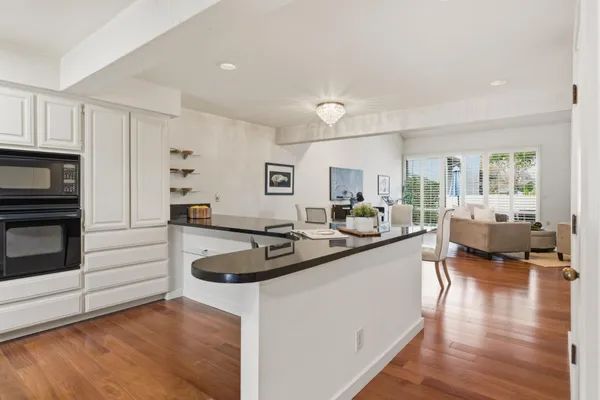 a kitchen with sink refrigerator and stove