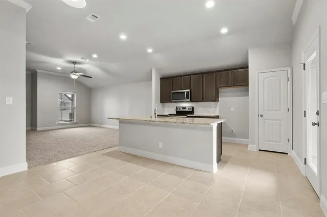 a view of kitchen with microwave and cabinets