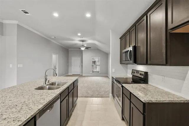 a kitchen with stainless steel appliances granite countertop a sink counter space cabinets and stainless steel appliances