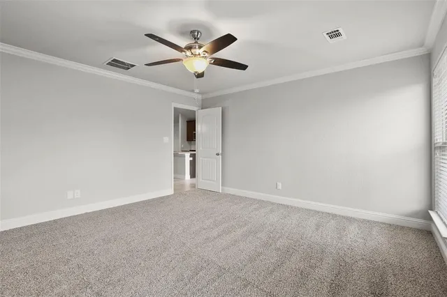 a view of an empty room with a ceiling fan