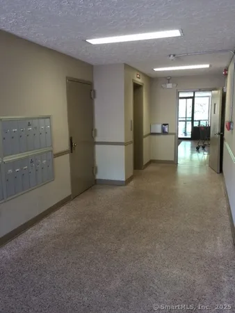 a view of empty room with kitchen
