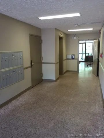 a view of empty room with kitchen