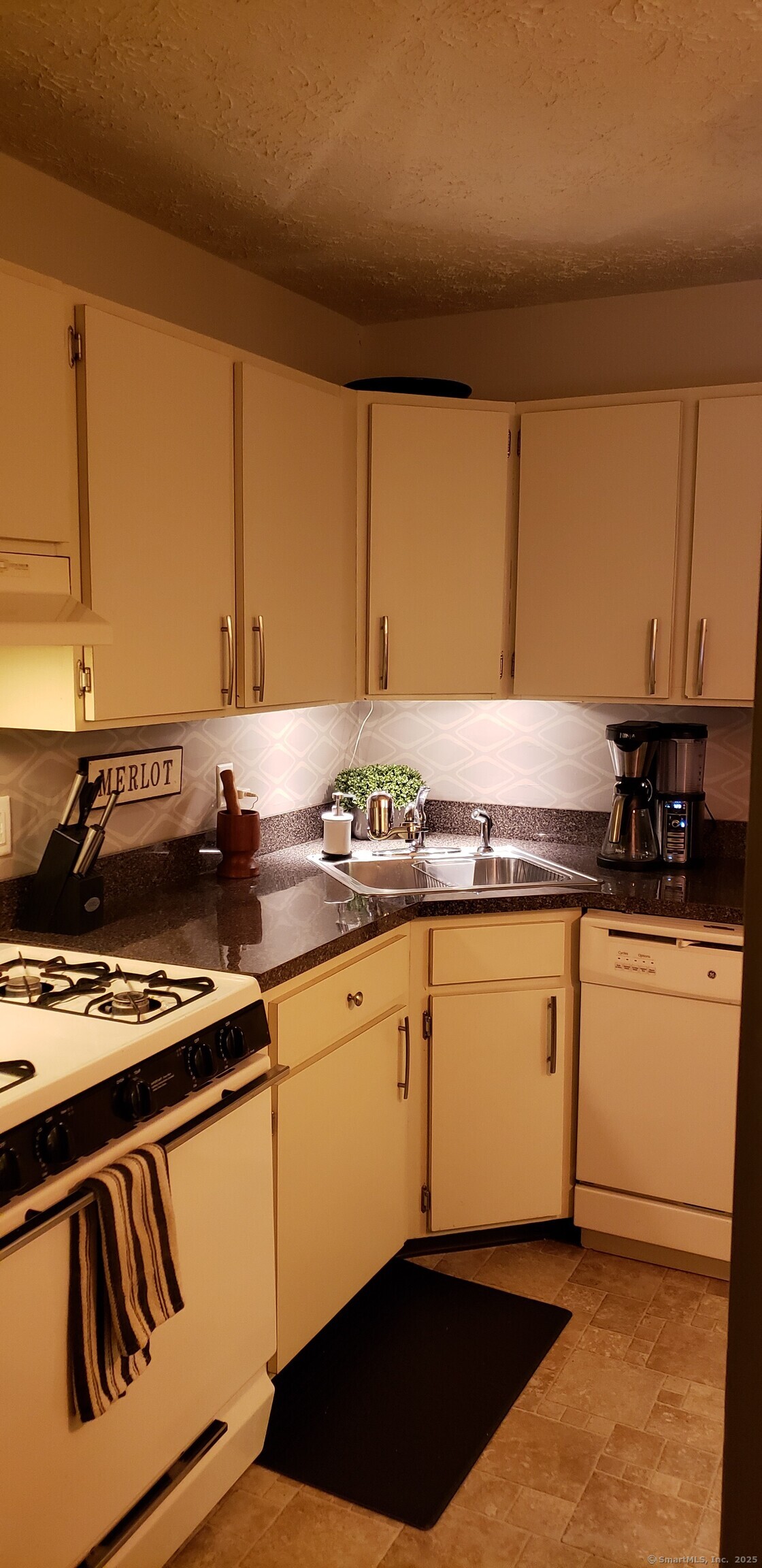 460 Savin Avenue West Haven, CT 06516 - Photo 9 of 10 a kitchen with granite countertop cabinets and black appliances