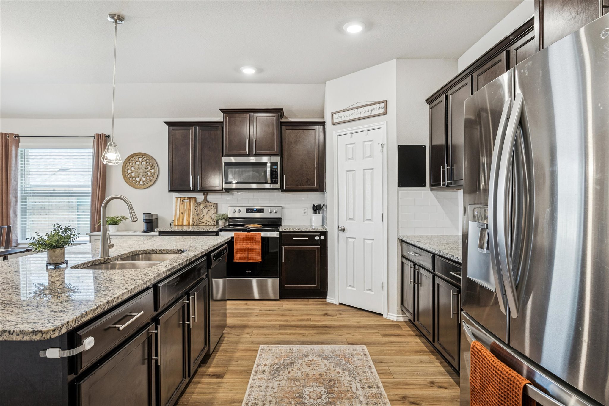 8902 Alabama Avenue Temple, TX 76502 - Photo 11 of 37 a kitchen with stainless steel appliances granite countertop a refrigerator a stove and a sink