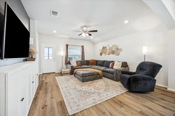 a kitchen with stainless steel appliances granite countertop a refrigerator a stove and a sink