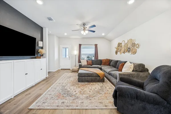a kitchen with granite countertop a sink cabinets and stainless steel appliances