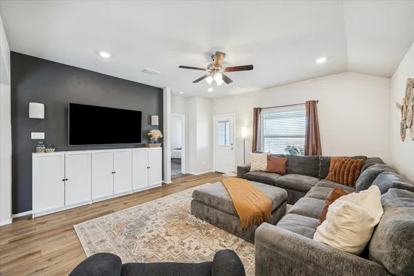 a living room with furniture fireplace and flat screen tv