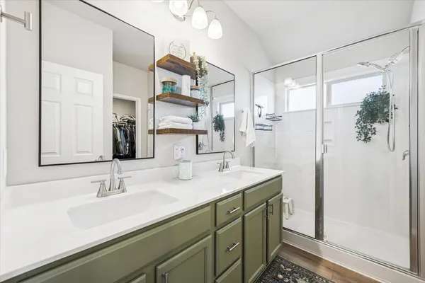 a bedroom with a bed and a ceiling fan