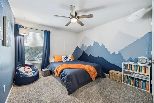 a bedroom with furniture and a window