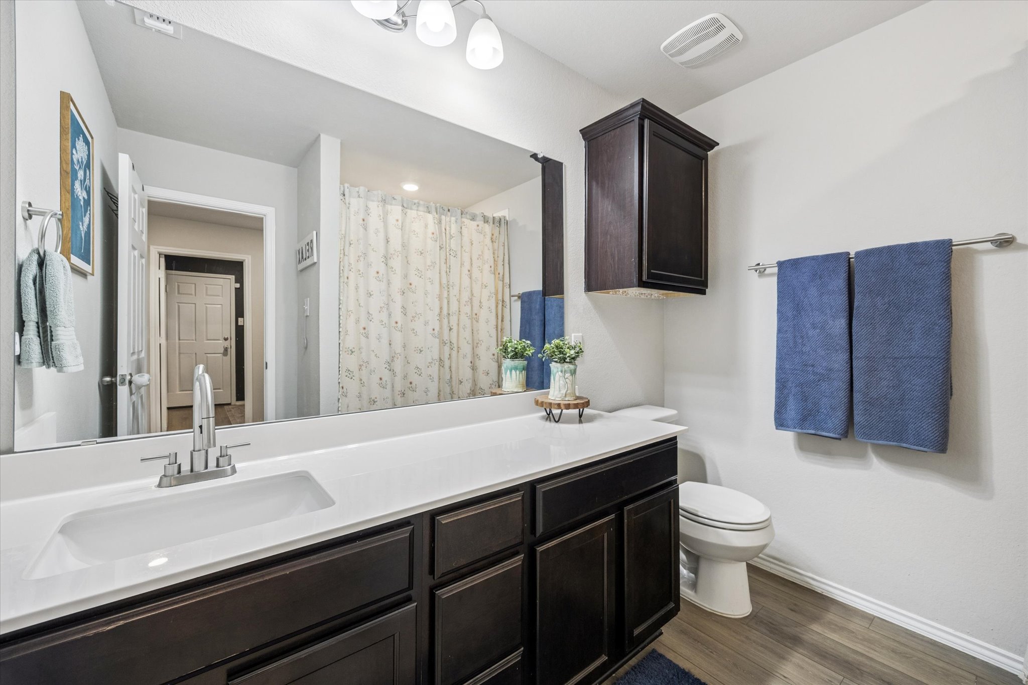 8902 Alabama Avenue Temple, TX 76502 - Photo 24 of 37 a bathroom with a double vanity sink toilet and mirror