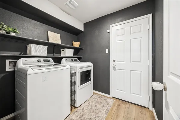 a bed sitting in a bedroom next to a book shelf