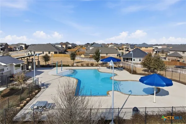 an aerial view of a house with outdoor space and lake view in back