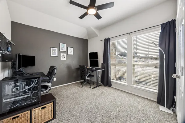 a view of a livingroom with workspace and a window
