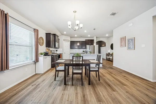 a view of a dining room with furniture and wooden floor