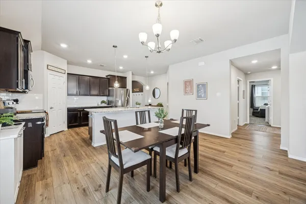a view of a dining room with furniture and wooden floor