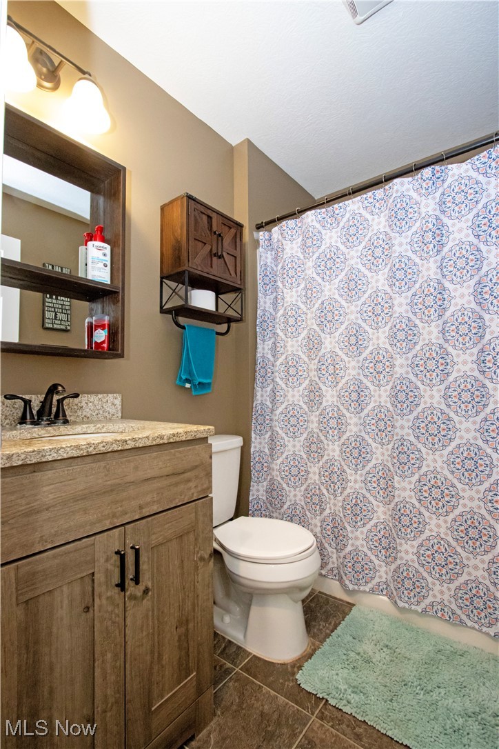 8249 Town Line Road Shiloh, OH 44878 - Photo 20 of 34 Full bath with vanity, tile patterned flooring, and curtained shower