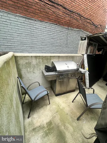 a view of a patio with table and chairs