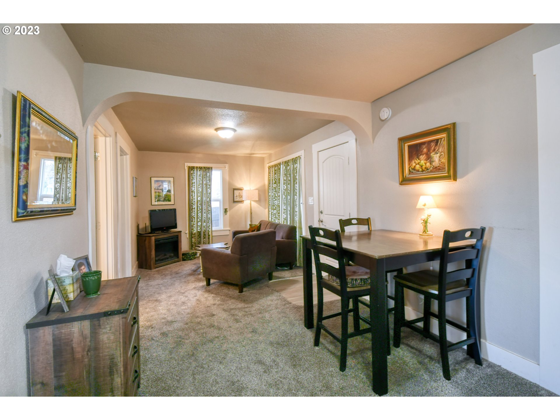 207 Southwest Isaac Avenue Pendleton, OR 97801 - Photo 11 of 32 a living room with furniture potted plant kitchen view and a table