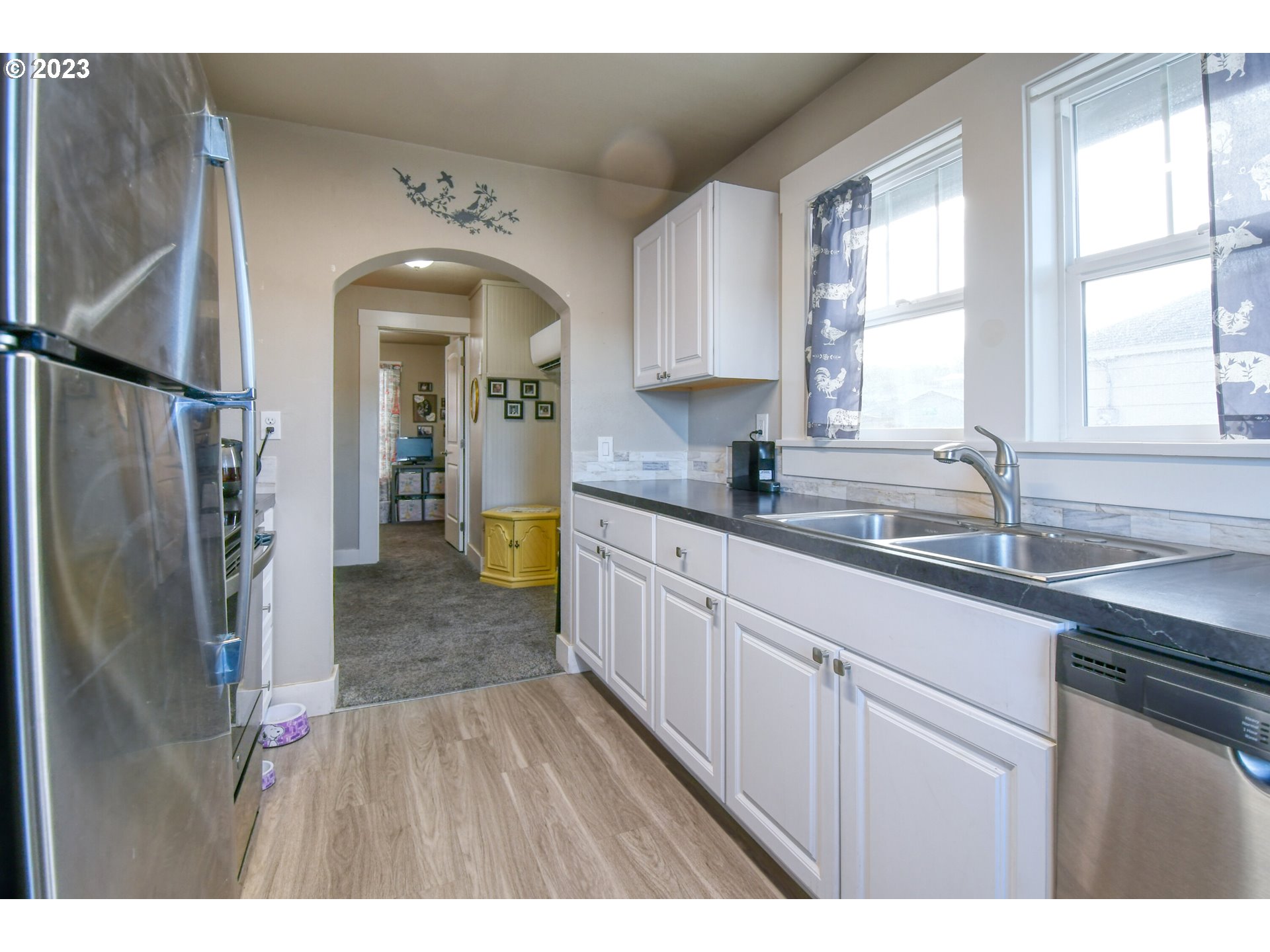 207 Southwest Isaac Avenue Pendleton, OR 97801 - Photo 14 of 32 a kitchen with stainless steel appliances a refrigerator sink and cabinets