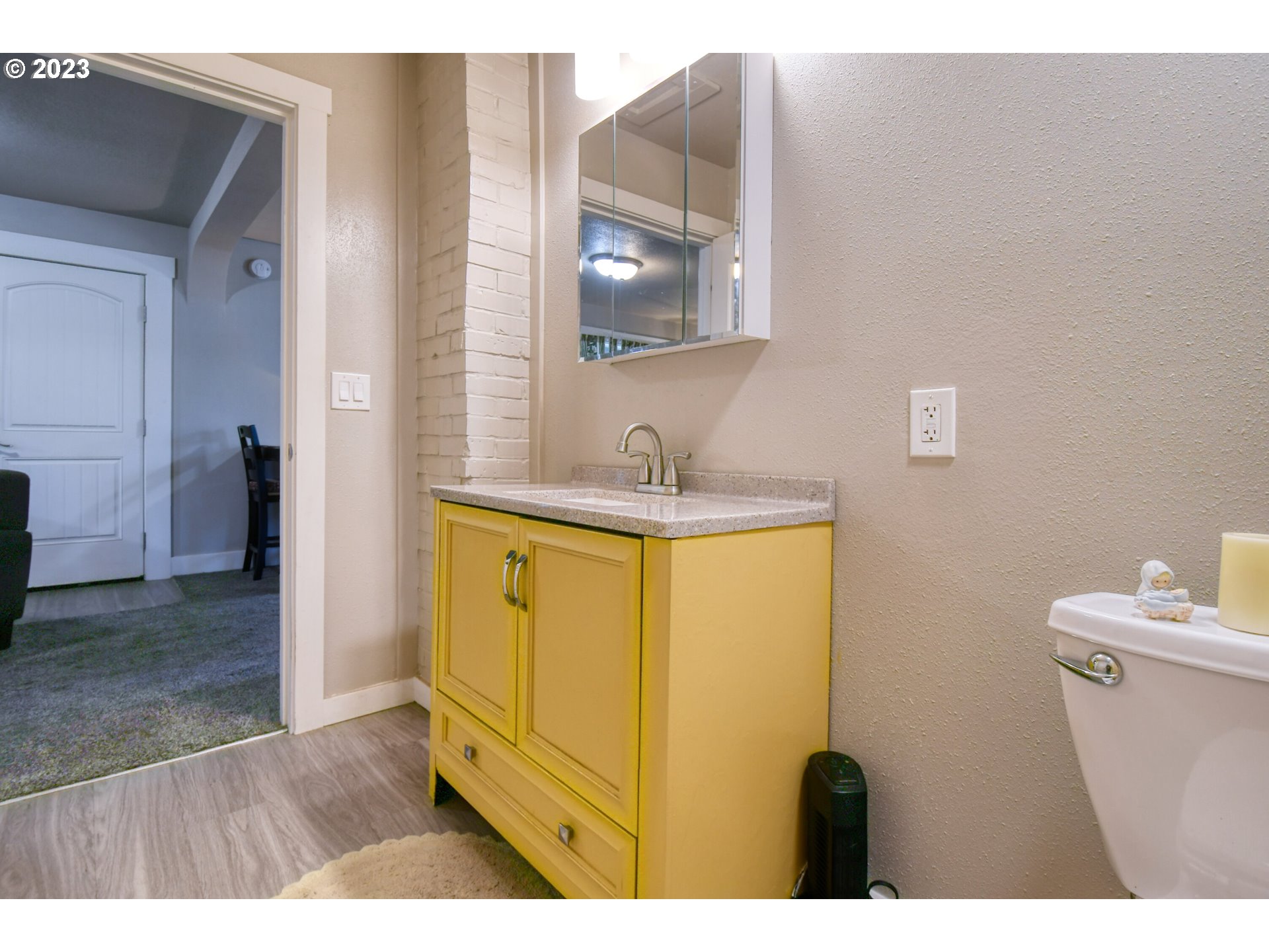 207 Southwest Isaac Avenue Pendleton, OR 97801 - Photo 24 of 32 a bathroom with a sink a toilet and a mirror