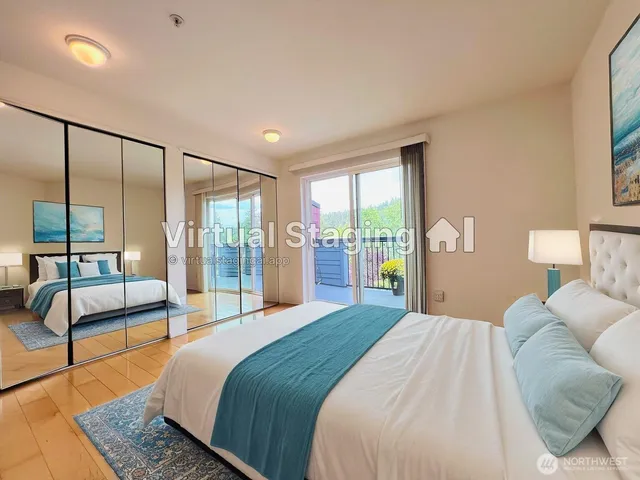 a bedroom with a large bed and a view of balcony