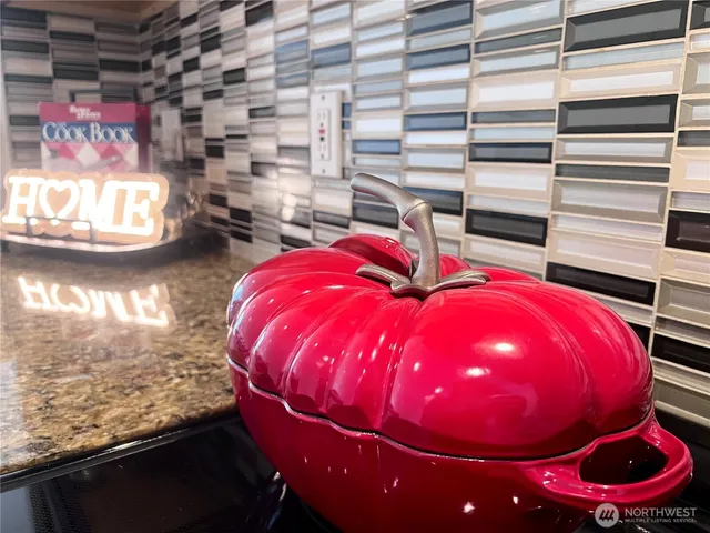 a view of a wooden floor with a table and chairs