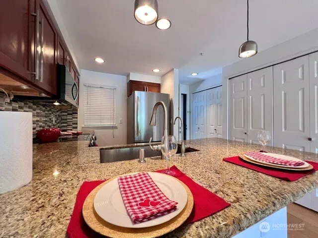 a room with kitchen island granite countertop furniture and a fireplace