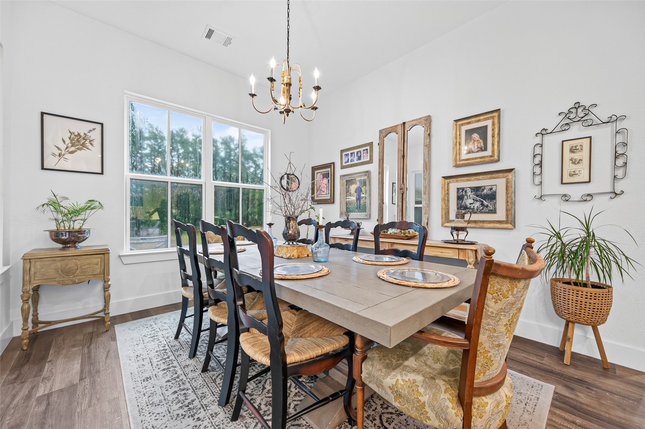 10915 Ruger Road Willis, TX 77378 - Photo 18 of 50 a view of a dining room with furniture a chandelier and wooden floor