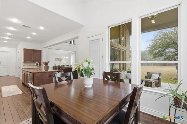 a view of a dining room with furniture window and outside view