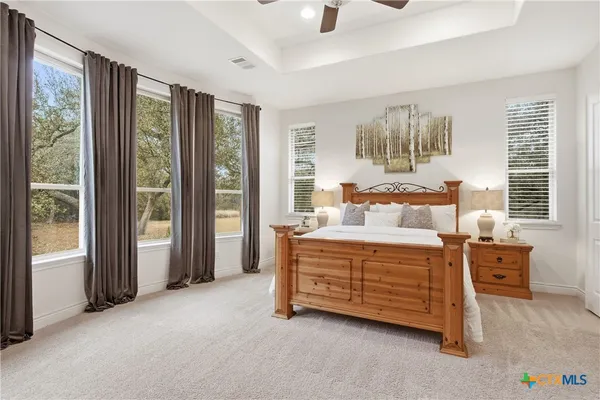 a spacious bedroom with a bed and a large window