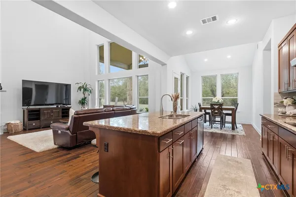 a kitchen with counter top space and wooden floor