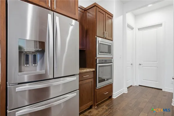 a kitchen with appliances and cabinets