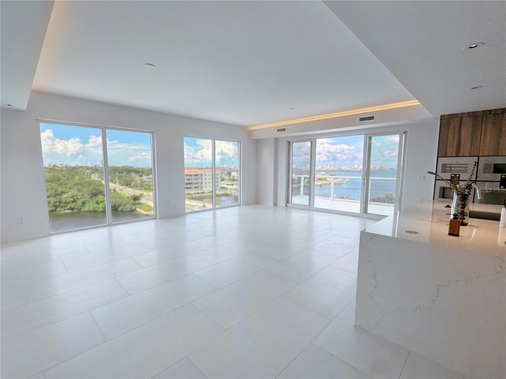 1020 Sunset Point Road, Unit 609 Clearwater, FL 33755 - Photo 3 of 20 wooden floor in an empty room with a window