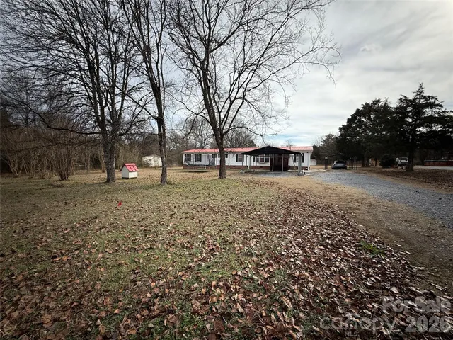 a view of a yard with a house and trees