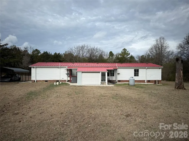 a view of a house with a yard and garage